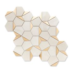 the white and gold mosaic tiles are arranged on top of each other, with different shapes