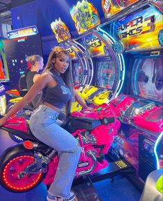 a woman sitting on a pink motorcycle in front of a slot machine at a casino