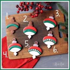 cookies decorated with the colors of the flag are on a cutting board next to holly branches