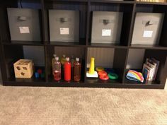 the shelves are filled with different types of toys and storage bins on top of them