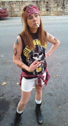 a woman with tattoos standing in the street