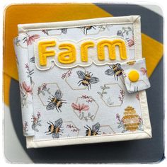 a small wallet with the word farm on it's front and bees in the back