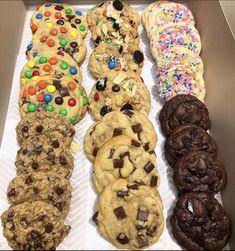 a box filled with lots of different types of cookies and doughnuts next to each other