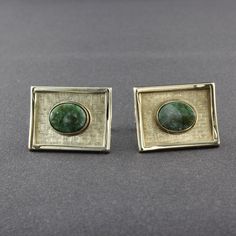 Made by Destino, this is an attractive pair of genuine green mottled jade shiny gold tone rectangular cufflinks. The slightly curved cufflinks have a background that has a tight crosshatch line design and a raised smooth border. In the center is an oval shaped, bezel set piece of polished dark green jade. The shank is attached to the back of the cufflinks with a moveable hinge. A nice size, they measure 7/8 inch wide, 5/8 inch tall and 1/8 inch thick. The jade is 10mm wide and 7mm tall. The cuff Celebrity Engagement Rings, Curling Ribbon, Gold Cufflinks, Vintage Cufflinks, Tie Clips, Tie Tack, Tie Accessories, Green Jade, Cuff Links