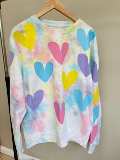 Say Hello to the start of the New Wonky Heart Range  This is a pastel Tie Dye sweatshirt with pastel wonky hearts printed on top. These jumpers will be unique to you, no two will be the same. Stand out from the crowd in the cutest jumper to hit this season. Each jumper is hand dyed and hand printed for you. Can you ever have too many hearts? Any questions please feel free to message. Playful Multicolor Spring Sweatshirt, Cute Multicolor Heart-shaped Tops, Cute Multicolor Crew Neck Sweatshirt, Trendy Multicolor Sweatshirt For Spring, Cute Pastel Crew Neck Tops, Multicolor Heart Print Crew Neck Top, Trendy Pastel Crew Neck Top, Playful Pastel Tops For Spring, Spring Long Sleeve Sweatshirt With Heart Graphic