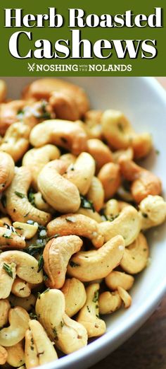 a white bowl filled with cashews on top of a wooden table