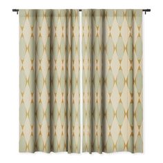 an open window curtain with gold and white geometric designs on the outside, in front of a light green background