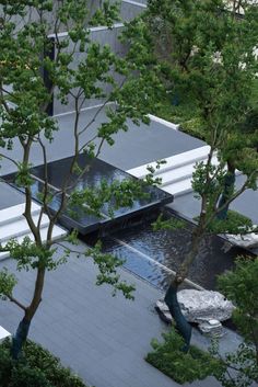 an aerial view of a house with trees and water