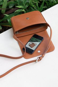 Smooth leather crossbody bag, lined with cotton fabric. It features a front flap with magnetic snap closure it has a roomy compartment, a slim interior pocket, and one exterior pocket.The strap is adjustable. Leather Dye, Nice Leather, Vegetable Tanned Leather, Green And Brown, Slow Fashion, Smooth Leather, Tan Leather, Leather Crossbody Bag, Snap Closure