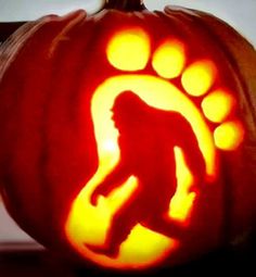 a carved pumpkin with an image of a bigfoot on it