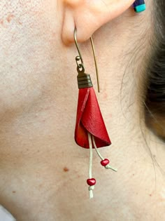 a close up of a person wearing some kind of earrings