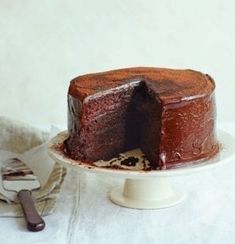 a chocolate cake sitting on top of a white plate