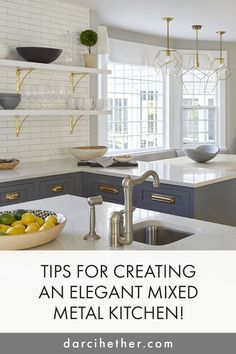 an elegant kitchen with white and gray cabinets, marble counter tops, gold accents and hanging lights