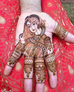 a woman's hand painted with henna