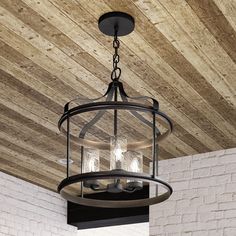 a chandelier hanging from the ceiling in a room with wood paneling and brick walls