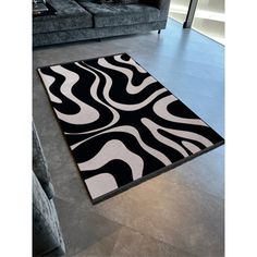 a black and white area rug in a living room