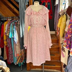 Approximate Size UK 20 Cute vintage pink floral cottagecore dress with an elasticated waist, long sleeves, front button fastening to the waist. It features a matching belt and a sweet ruffled collar. Approximate Measurements Shoulder 19" Chest 49" waist up to 48" Length 46" Pastoral Prairie Dress With Ruffles For Spring, Spring Pastoral Prairie Dress With Ruffles, Pink Prairie Dress For Daywear In Spring, Pink Prairie Dress For Spring Daywear, Pink Vintage Prairie Dress For Daywear, Vintage Pink Prairie Dress For Daywear, Vintage Pink Prairie Dress For Summer, Frilly Collar, Floral Cottagecore