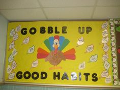 a bulletin board with a turkey saying gobble up good haits on the front