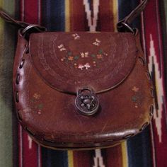 Vtg 70's Hand Tooled Hippie Floral Leather Bag Purse .Great Shape .Nice Patina .Twist Dial Lock . It's Aprox 8 1/2" At Base ,9 1/4 Across At Middle ,4 1/2" Deep ,8 1/2" Tall . Retro Hand-tooled Bags, Vintage Brown Hand Tooled Bag, Vintage Bags With Coin Pocket, Vintage Hand Tooled Brown Shoulder Bag, Vintage Brown Bags With Coin Pocket, Vintage Shoulder Bag With Coin Pocket, Vintage Rectangular Bag With Coin Pocket, Vintage Satchel Shoulder Bag With Coin Pocket, Vintage Shoulder Bag With Coin Pocket For Daily Use