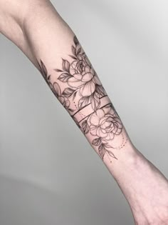 a woman's arm with flowers on it