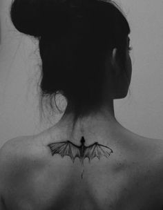 a woman with a bat tattoo on her back