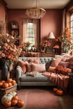 Revel in the splendor of this exquisite living room that artfully embodies the essence of autumn. Draped in luxurious velvety furnishings and adorned with a cornucopia of fall wall decor, this room is a respite for the soul. The blush pink and pumpkin hues blend with the richly colored dried florals cascading around the room. An opulent crystal chandelier is the crowning glory, while the plush sofa, festooned with cushions, beckons you to relax. This space is the epitome of fall grandeur.