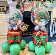 two clear balls with presents wrapped in red and green ribbons on them, sitting next to each other