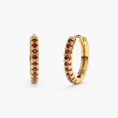 Add a touch of vibrant sparkle to your jewelry collection with these 14k gold huggie hoop earrings. Each earring features a delicate huggie clasp and a dazzling line of natural pink rubies. Their soft pink hues and unique design offer sophisticated elegance for any occasion. Choose from classic yellow, cool white, or trendy rose gold. - Handmade - Solid Gold - Natural Rubies - Total Ruby Carat Weight:      - 10mm: 0.09 ctw      - 11mm: 0.10 ctw      - 12mm: 0.13 ctw - Diameters:      - 10 mm: Ou Solid Gold Bracelet, Huggie Earring, Small Hoop Earrings, Beautiful Gift Wrapping, Ruby Earrings, Initial Jewelry, Name Jewelry, Earrings Small, Diamond Gold