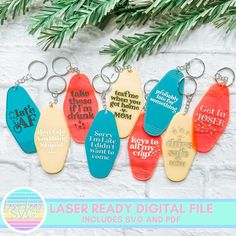 six key chains with different sayings on them hanging from a christmas tree branch in front of a white brick wall