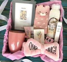 a pink gift box filled with personal care items