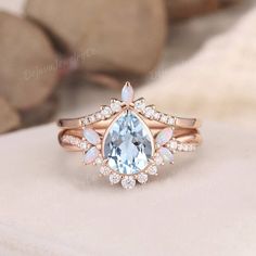 Unique Aquamarine Engagement Ring Pear Shaped Bridal Set Unique Vine Butterfly Floral Rose Gold Baby Blue Bezel Marquise Birthstone 2pcs ✦ Handmade, high-quality item ✦ Material: SOLID 10K/14K/18K GOLD ( can be made in yellow/white/rose gold ) ✦Engagement ring ✦ Center stone: Natural Aquamarine ✦ Size/Weight: 6*8mm ✦ Color: Blue ✦ Cut: Pear Shaped ✦ Side stones: Moissanite or Natural Diamonds; lab opals  ✦ Weight: About 0.3ct  ✦ Band Width: Around 1.8mm ✦Wedding band  ✦ Side stones: Moissanite o Opal Wedding Ring Set, Engagement Ring Pear Shaped, White Opal Engagement Ring, Opal Wedding Ring, Ring Pear Shaped, Engagement Ring Pear, Opal Engagement Ring, Opal Wedding, Rose Gold Flower