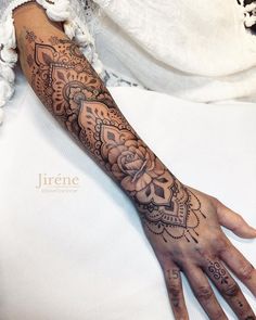 a woman's hand with a tattoo on it and an intricate design in the middle