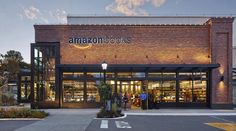 an amazon store front with people standing outside