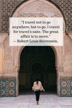 a woman walking through an archway with a quote on it