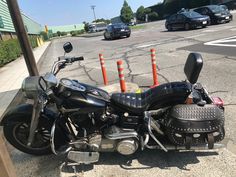 a motorcycle is parked on the side of the road in front of some orange cones