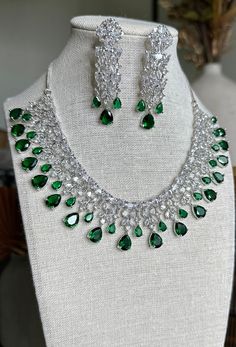 Emerald necklace with rhodium plating- necklace has an adjustable hook backing with matching earrings included. Perfect occasion jewelry set for a formal event. Teardrop Necklace With Matching Earrings For Parties, Party Teardrop Necklace With Matching Earrings, Teardrop Costume Jewelry Necklace For Formal Occasions, Teardrop Costume Jewelry For Formal Occasions, Silver Jewelry Sets With Matching Earrings For Formal Occasions, Sterling Silver Necklace With Matching Earrings For Formal Events, Sterling Silver Bridal Necklace For Party, Formal Dangle Necklace With Elegant Design, Elegant Teardrop Jewelry Sets For Party