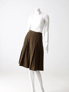 "This is a vintage pleated skirt circa 1950s - 1960s. The brown and black woven tweedy skirt has box pleats and falls just below the knee. Metal zipper closure with button top. CONDITION In good condition with wear consistent with age and use. APPROXIMATE FIT: S MEASUREMENTS Waist: 26\" .. 66 cm Length: 26.25\" .. 66.7 cm 721114" Tweed Pleated Skirt For Work, Fitted Tweed Pleated Skirt, Vintage Pleated Skirt For Workwear In Fall, Vintage Pleated Fall Skirt For Workwear, Vintage Brown Wool Skirt, Brown Vintage Wool Skirt, Vintage Skirt Outfit, 1960s Skirt, 60s Skirt