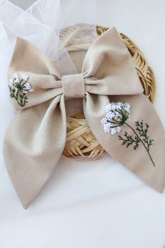 a bow with flowers on it sitting in a basket