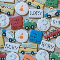 decorated cookies with numbers, cars and trucks are on the table for children's birthday party