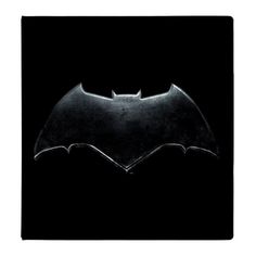 the dark knight batman logo on a black background, with only one light shining in it