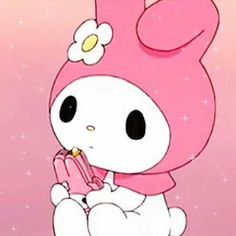 hello kitty sitting on top of a stuffed animal with a flower in it's hair