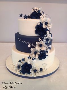 a three tiered cake with blue and white flowers