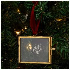 an ornament hanging from a christmas tree in the shape of a square frame