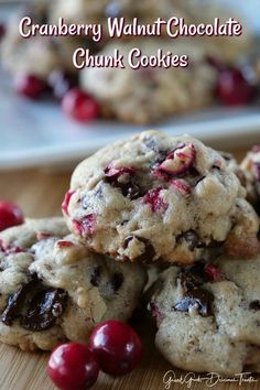 cranberry walnut chocolate chunk cookies are stacked on top of each other and ready to be eaten