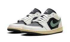 The Women’s Air Jordan 1 Low "Jade Smoke" is a women’s-exclusive colorway of the retro basketball shoe that is reminiscent of Travis Scott’s collaborative version of the model.  Inspired by Travis Scott’s Air Jordan 1 Low “Olive,” the “Jade Smoke” has a similar color block as the hip-hop star’s take on the model.  Specifically, the upper is complete with an Anthracite-colored leather base and Sail leather overlays.  A Jade Smoke leather Swoosh can be found on either side of the shoe, while a whi Air Jordans Stadium Goods, Jordan Shoes Stadium Goods, Low Jordans, Womens Air Jordan 1, Womens Air Jordan, Retro Basketball Shoes, Retro Basketball, Stadium Goods, Air Jordan 1 Low