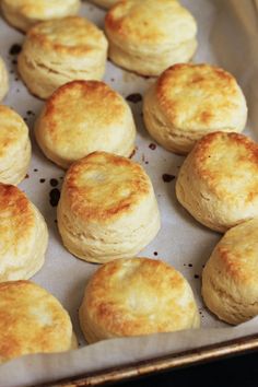 some biscuits are sitting on a baking sheet and ready to be baked in the oven