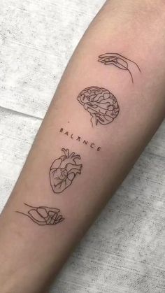 a person with a tattoo on their arm that says balance and two hands holding a heart