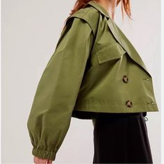 Price Includes Shipping Note New But Without Free People Tag Embrace A Modern Take On A Classic In The Free People Looking Glass Trench Coat In Loden Green. This Cropped Trench Boasts Dual Breasted Design, Front Button Closure, And Handy Breast Flap Pockets. The Elastic Cuffs And Hem, Combined With The Durable Twill Fabric, Offer A Blend Of Playful And Professional. Ideal For Adding A Chic Layer To Your Outfit. Shell: 57% Cotton 34% Polyester 9% Polyamide Lining: 100% Polyester Machine Wash Dual Cool Trench Coat, Loden Green, Cropped Trench Coat, Exaggerated Collar, Free People Jacket, Green Coat, Twill Fabric, Vest Jacket, Trench Coat