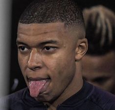 a close up of a person sticking his tongue out