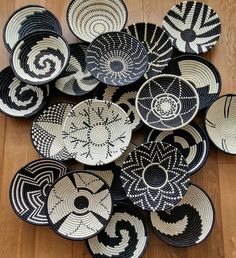 many black and white plates on a wooden floor